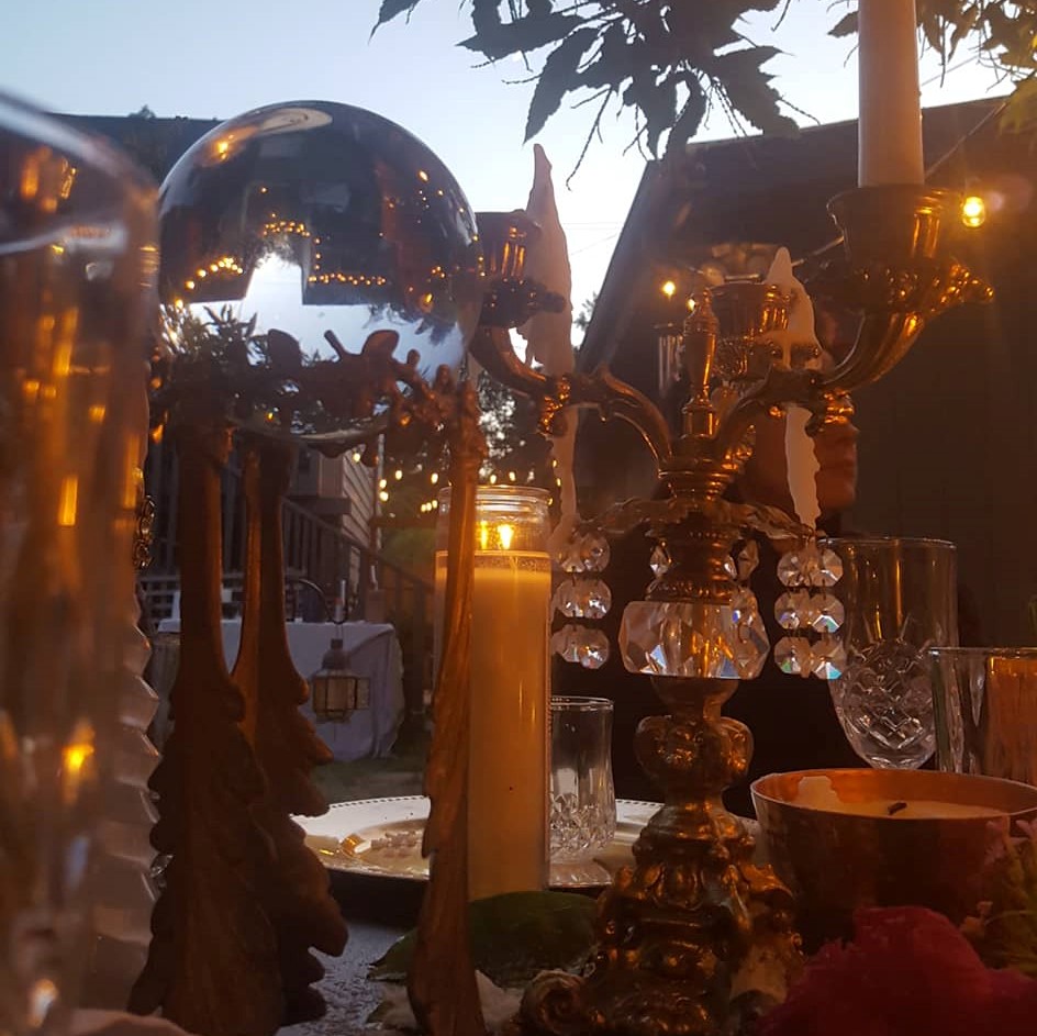 Assorted candles, crystals, and witchery adorn the banquet table
